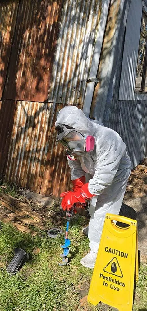 MelBuzz™ technician installing in-ground termite baiting system, Melbourne.