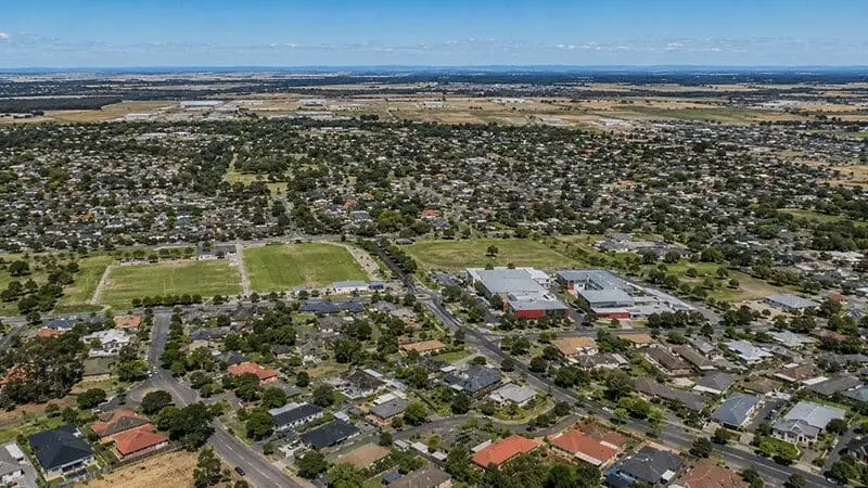 Aerial view of residential Melbourne suburbs, showcasing the service area for Melbuzz Pest Control, protecting
