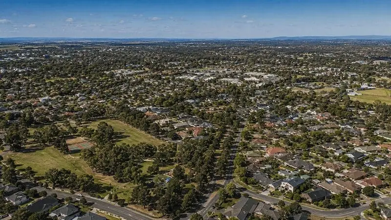 Aerial view of residential homes and green spaces in Melbourne, Australia, illustrating the extensive service
