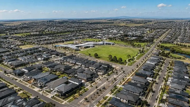 Aerial view of a suburban landscape in Melbourne, Australia, showcasing rows of houses